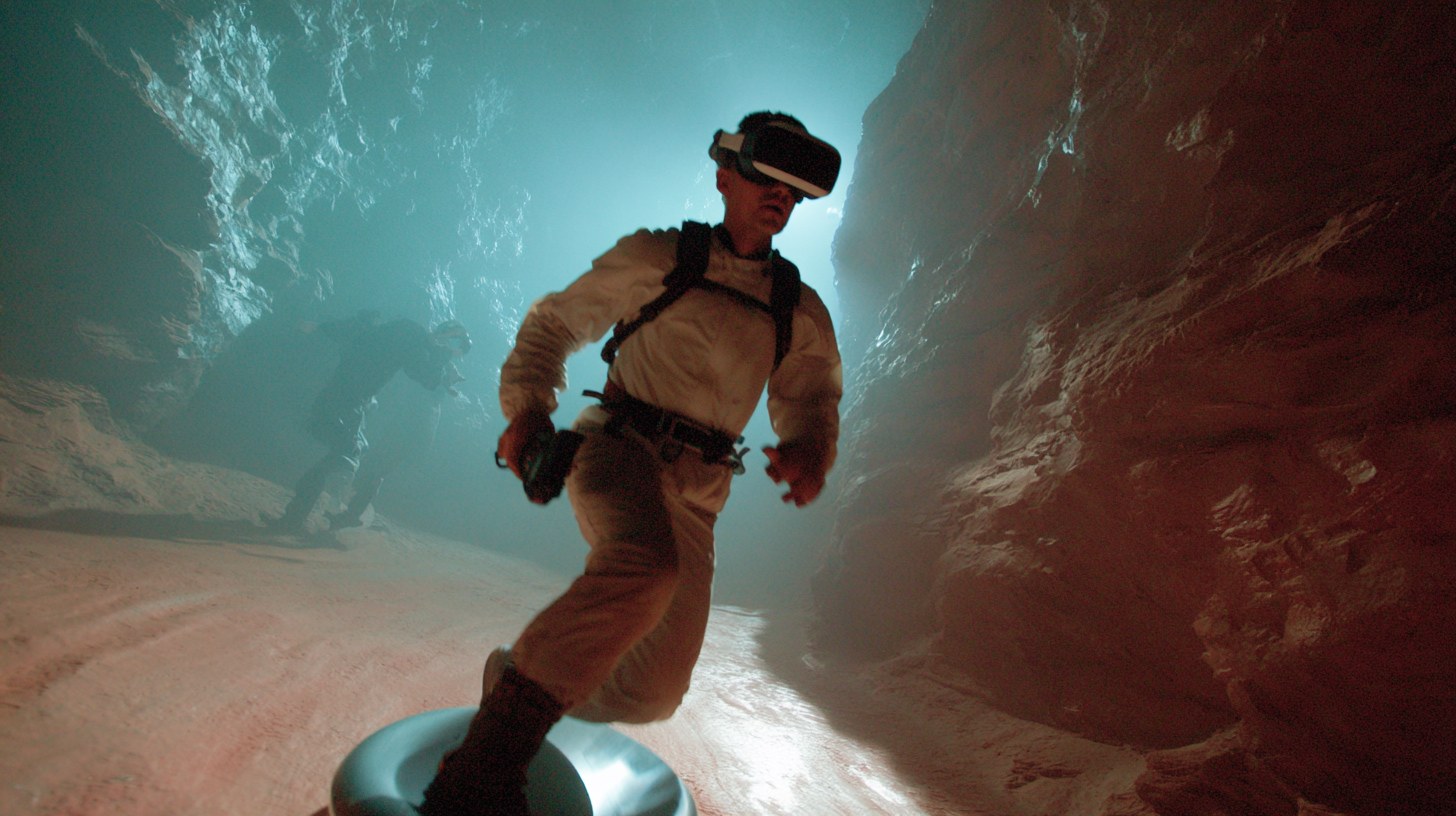 A player running on the 360-degree dish treadmill in goggles and a harness ring